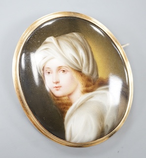 A yellow metal mounted porcelain miniature oval brooch, painted with a young boy, 64mm, gross weight 25.1 grams.